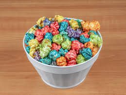 A bucket filled with colorful, flavored popcorn.