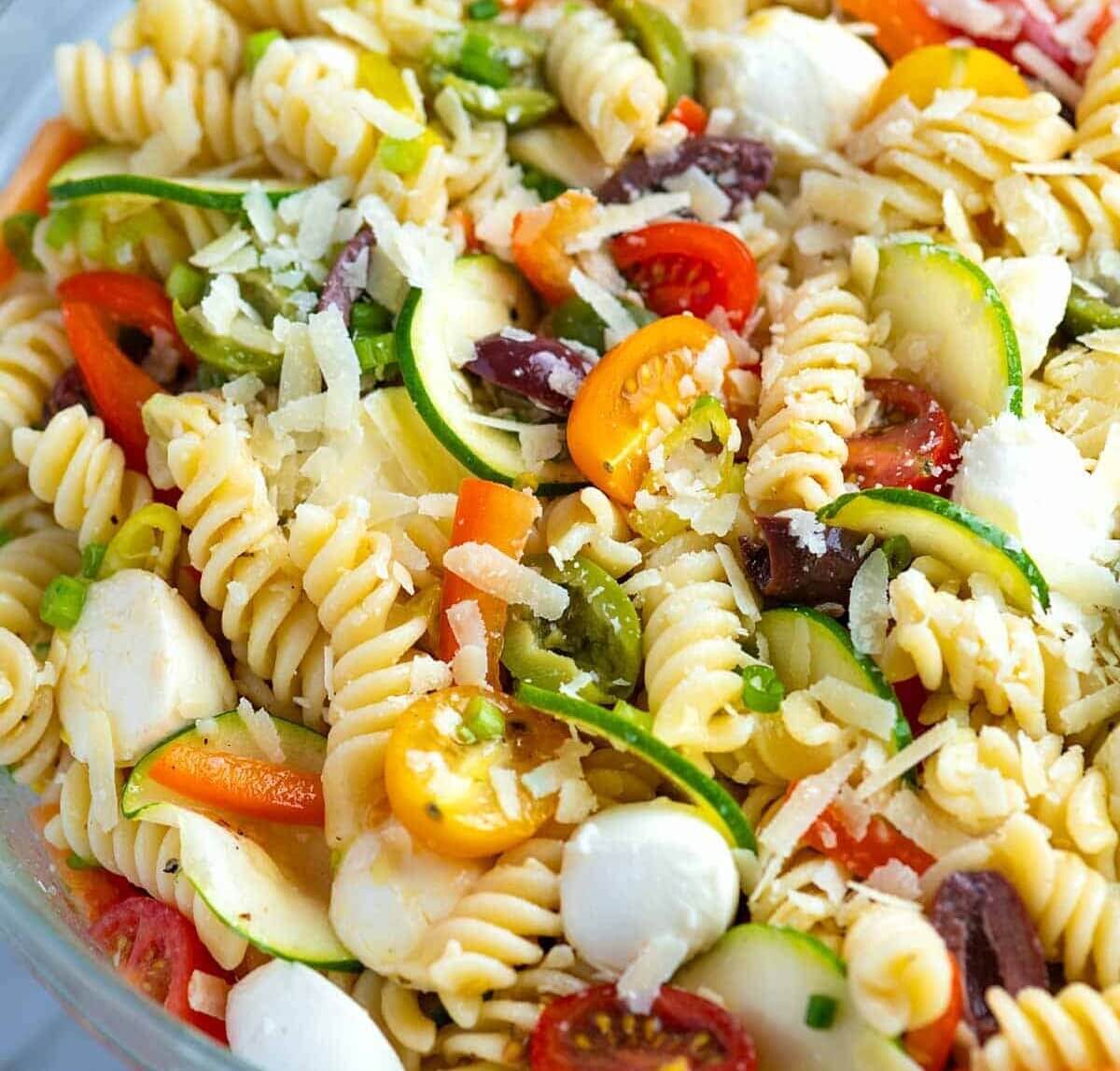 Colorful pasta salad with fresh vegetables and herbs.